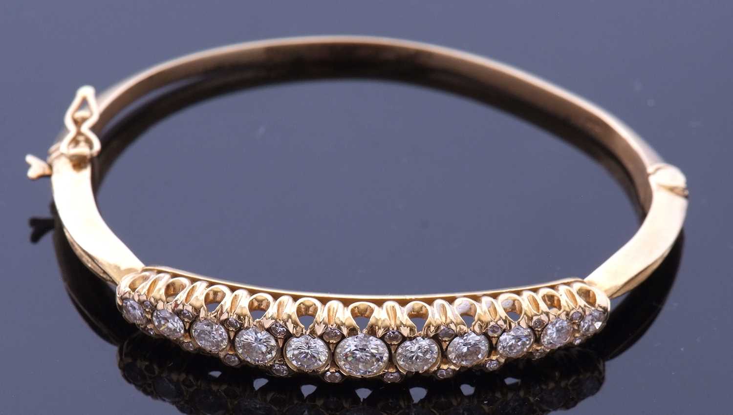 Lot 203 - 18ct gold and diamond hinged bracelet