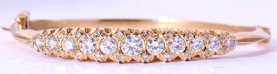 Lot 203 - 18ct gold and diamond hinged bracelet