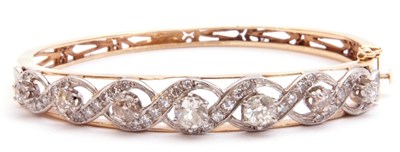 Lot 204 - Diamond set hinged bracelet, featuring seven...