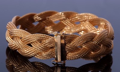Lot 230 - 750 stamped bracelet, a woven plaited design,...
