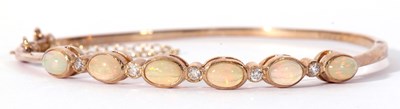 Lot 260 - 9ct gold opal and diamond set hinged bracelet,...