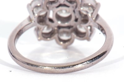 Lot 167 - Precious metal and diamond cluster ring...