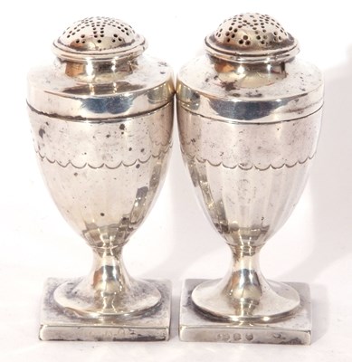 Lot 124 - Pair of George III silver peppers of urn form,...
