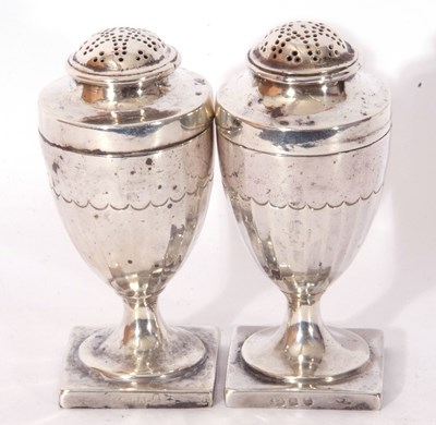 Lot 124 - Pair of George III silver peppers of urn form,...