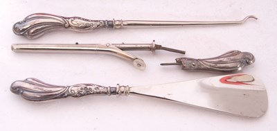 Lot 165 - Cased button hook, tongs and shoe horn, each...