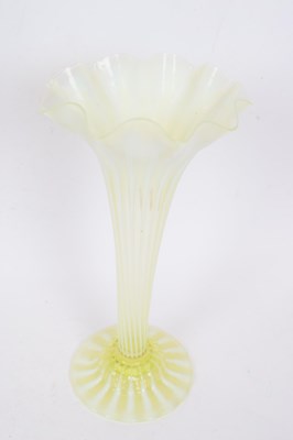 Lot 47 - Tall green vaseline glass vase with a striped...