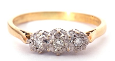 Lot 40 - A three stone small diamond ring featuring...