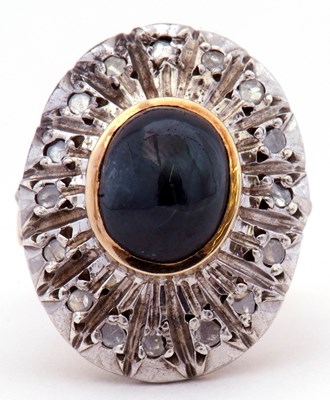 Lot 51 - Large dress ring centring a dark oval cabochon...