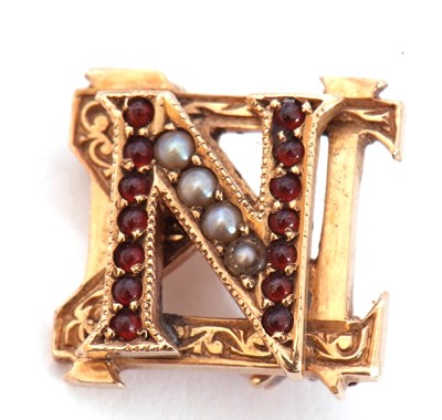 Lot 215 - Small yellow metal seed pearl and garnet...