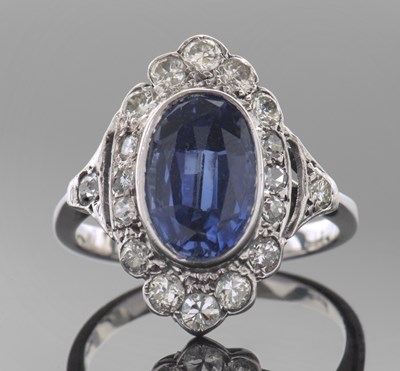 Lot 318 - Sapphire and diamond ring, the oval faceted...