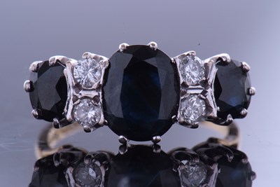 Lot 322 - Sapphire and diamond ring featuring three oval...