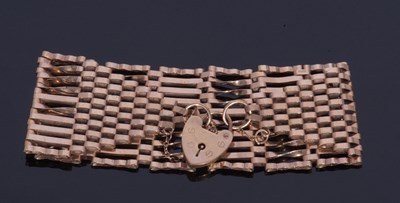 Lot 370 - 9ct gold wide link gate bracelet with heart...