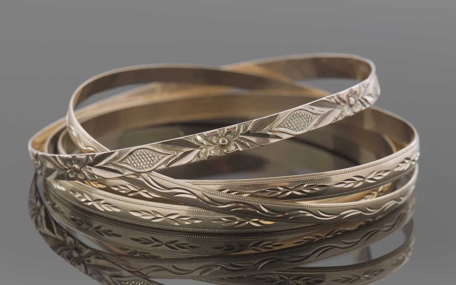 Lot 399 - Three hallmarked 9ct gold bangles and one...