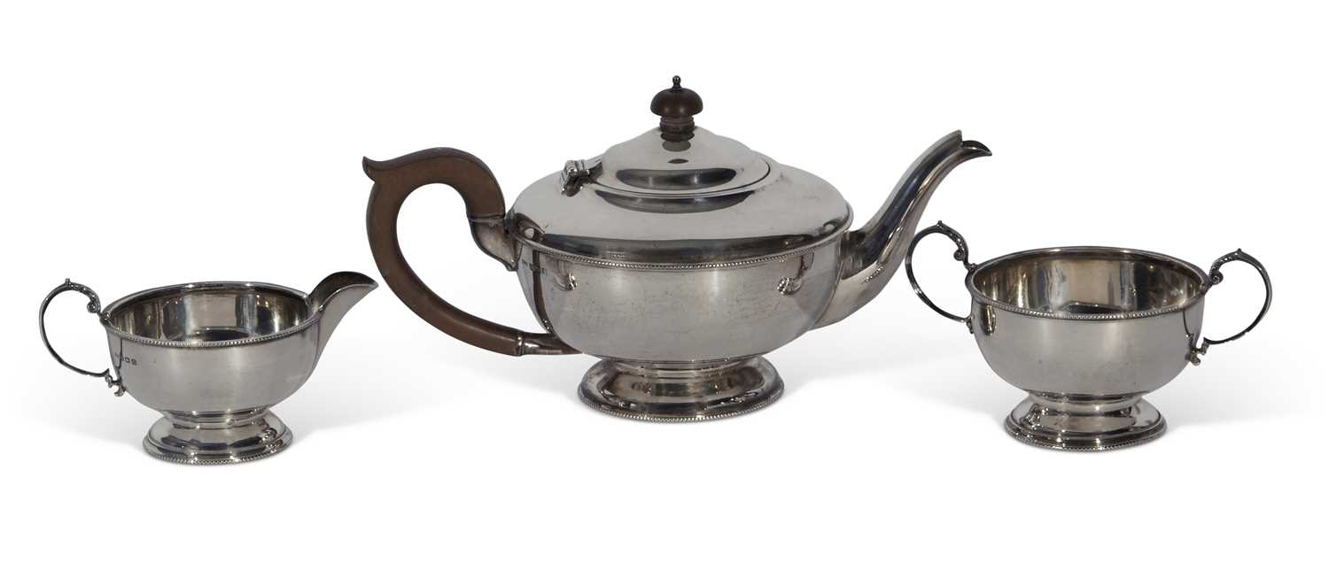 Lot 284 - George V three-piece tea set of circular form...