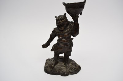 Lot 5 - Chinese bronze of a mythical figure holding a...