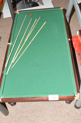Lot 318 - Miniature snooker table with cues, 64cm long