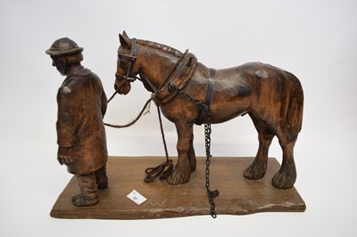 Lot 57 - Carved wooden ploughing horse on a rectangular...