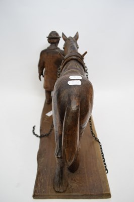 Lot 57 - Carved wooden ploughing horse on a rectangular...