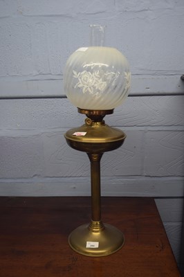 Lot 284 - Brass oil lamp with floral glass shade