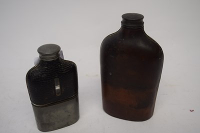 Lot 210 - Two leather spirit flasks, one with metal mounts