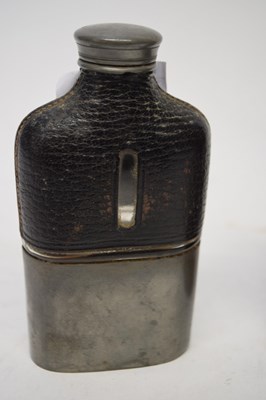 Lot 210 - Two leather spirit flasks, one with metal mounts