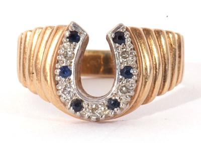 Lot 13 - 9ct gold diamond and sapphire horseshoe ring,...