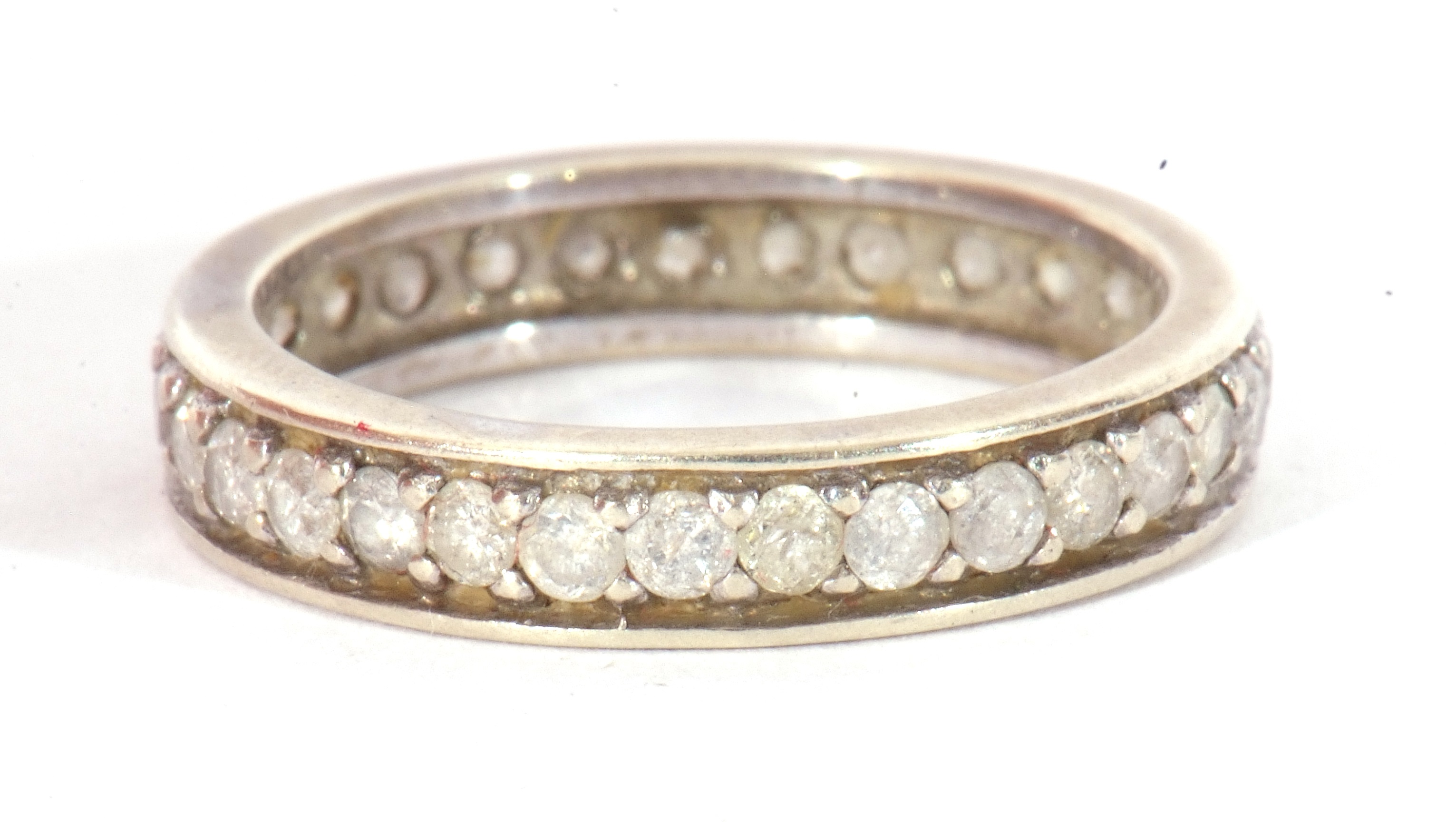 Lot 24 Precious metal and diamond eternity ring, a