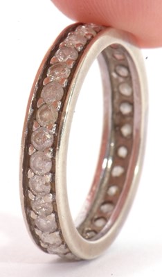 Lot 24 - Precious metal and diamond eternity ring, a...