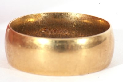 Lot 25 - 18ct gold wedding ring, the wide band of plain...