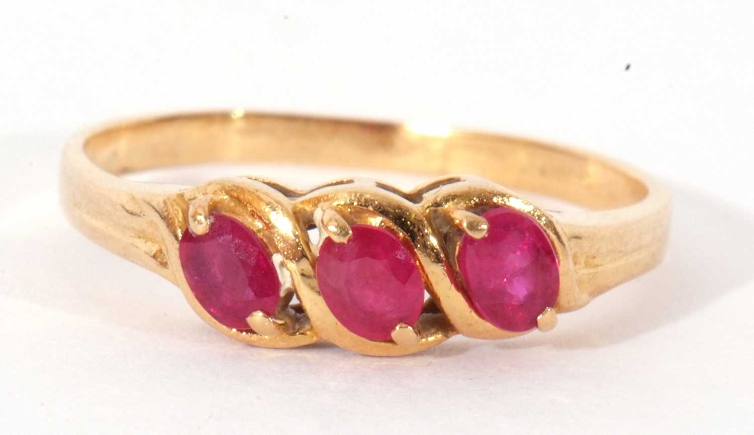 Lot 56 - Modern three stone ruby ring featuring three