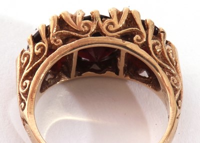 Lot 99 - 9ct gold three stone garnet ring featuring...