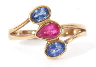 Lot 104 - Sapphire and ruby three stone ring, a stylised...