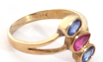 Lot 104 - Sapphire and ruby three stone ring, a stylised...