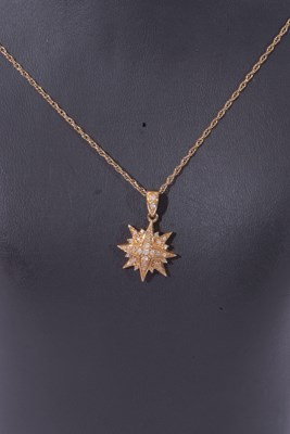 Lot 142 - 9ct gold starburst pendant highlighted...