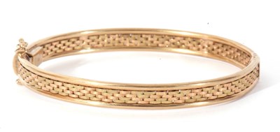 Lot 148 - 9kt stamped hinged bracelet, a textured and...