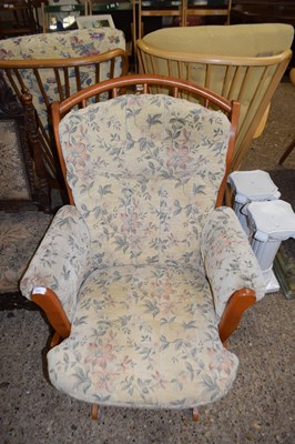 Lot 222 - MODERN FLORAL UPHOLSTERED ROCKING ARMCHAIR