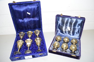 Lot 93 - TWO CASES OF MINIATURE BRASS AND SILVER PLATED...