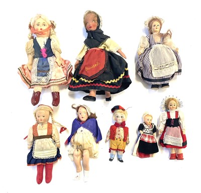 Lot 100 - A mixed lot of vintage dolls in traditional...