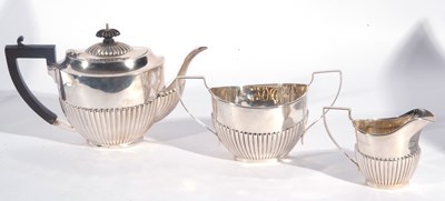 Lot 56 - George V silver three piece tea set of oval...