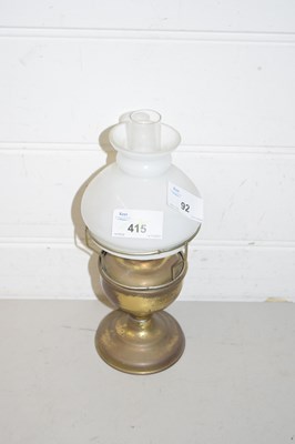 Lot 92 - A small brass oil lamp with shade