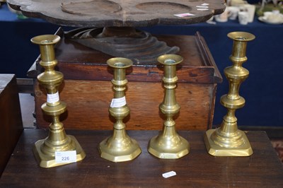 Lot 226 - Two pairs 19th Century brass candlesticks, the...