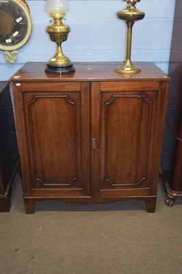 Lot 281 - Georgian mahogany two door cupboard, the panel...