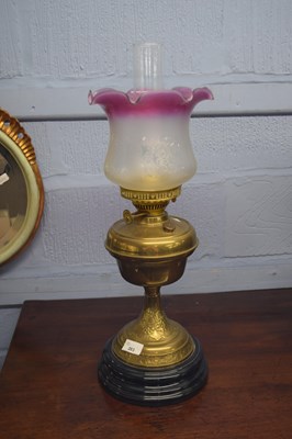 Lot 283 - Brass oil lamp with frilled frosted glass...