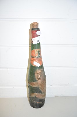 Lot 89 - VINTAGE GLASS BOTTLE DECORATED WITH A MONKEY