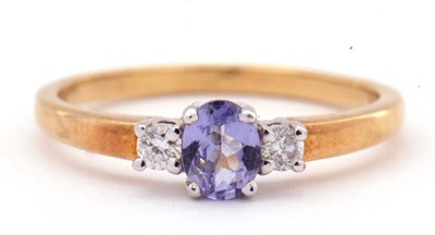 Lot 54 - Tanzanite and diamond three stone ring, the...