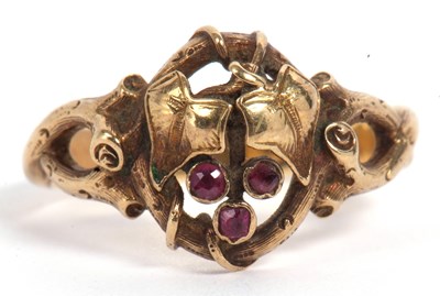 Lot 98 - Mid grade yellow metal and ruby ring, an open...