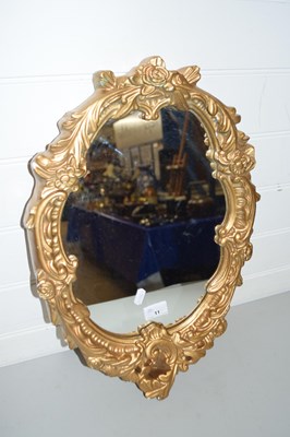 Lot 11 - OVAL MIRROR WITH A SHAPED GILT SCROLL BORDER