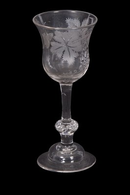 Lot 17 - A wine glass engraved with leaves and a...