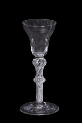 Lot 19 - A wine glass, the pan top above a knop air...