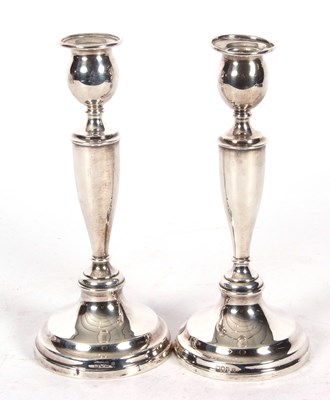 Lot 5 - A pair of George V silver candlesticks with...